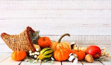 A cornucopia with gourds and fruit spilling out